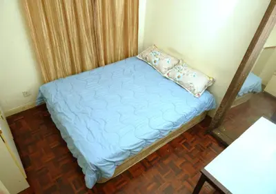 a small bedroom with a blue bed with a pillow at Cosy place at Serimaya condo in Kuala Lumpur