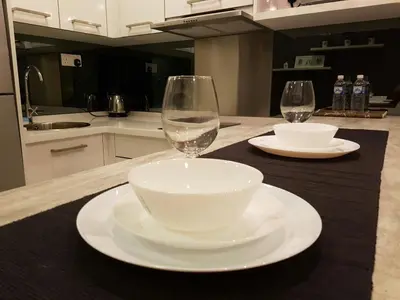 a table with a bowl and a wine glass on it at Summer Suites Studios in Kuala Lumpur