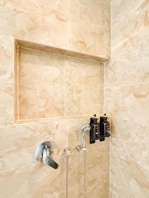 a shower with a faucet in a bathroom at TRX Pavilion Top Floor Suite, Kid-Friendly Slide, Dorsett Bukit Bintang KL, Kuala Lumpur Malaysia in Kuala Lumpur