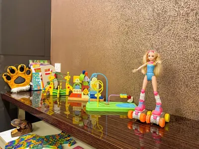 a barbie doll is standing on a counter with toys at TRX Pavilion Top Floor Suite, Kid-Friendly Slide, Dorsett Bukit Bintang KL, Kuala Lumpur Malaysia in Kuala Lumpur