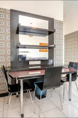 a dining room with a desk and chairs at Seri Bukit Ceylon By Katy in Kuala Lumpur