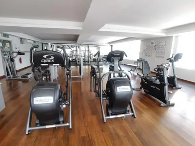 a gym with several treadmills and elliptical machines at Seri Bukit Ceylon By Katy in Kuala Lumpur