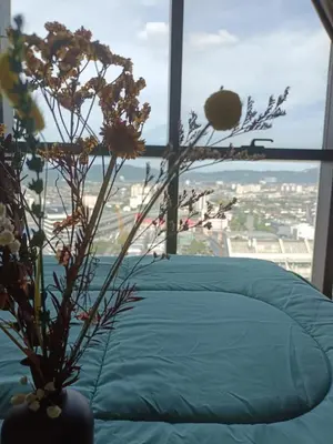 a bedroom with a bed and a window with flowers at The Elements Ampang A place of Tranquility Premium in Kuala Lumpur