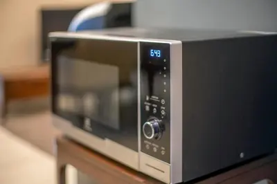 a microwave oven sitting on top of a table at Dorsett Residences Sri Hartamas Free Parking by COBNB Mont Kiara Kuala Lumpur in Kuala Lumpur