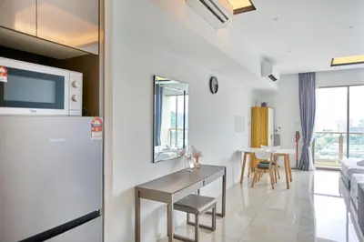 a kitchen and living room with a table and a couch at Dorsett Residences Sri Hartamas Free Parking by COBNB Mont Kiara Kuala Lumpur in Kuala Lumpur