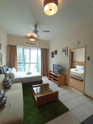 a living room with a couch and a bed at Sky suite at Seri Bukit Ceylon in Kuala Lumpur
