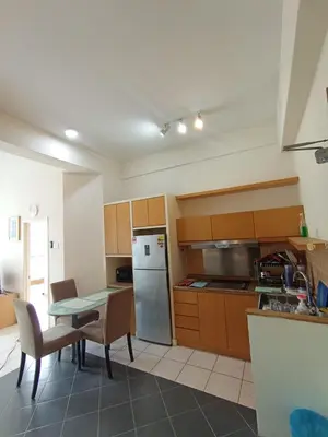 a kitchen with a refrigerator and a table with chairs at Sky suite at Seri Bukit Ceylon in Kuala Lumpur