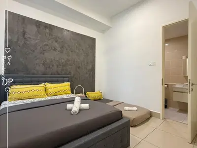 a bedroom with a bed with yellow pillows at Infinity Pool 7pax City Homestay KL Mrt Velo TRX in Kuala Lumpur
