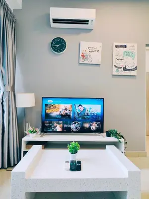 a living room with a white table and a tv at Arte Plus by Stay Relax in Kuala Lumpur