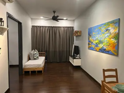 a living room with a couch and a painting on the wall at V Residence Suites, Sunway Velocity by Rasbo Galaxy Suites in Kuala Lumpur