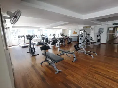 a gym with several treadmills and exercise bikes at Seri Bukit Ceylon apartment in Kuala Lumpur