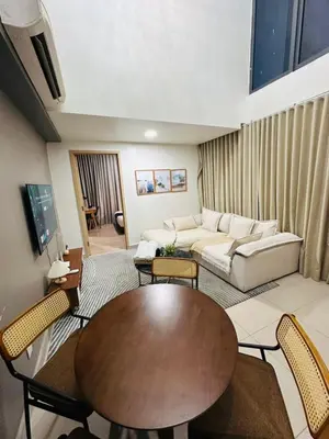 a living room with a table and a couch at The Colony By Infinitum With Klcc View in Kuala Lumpur