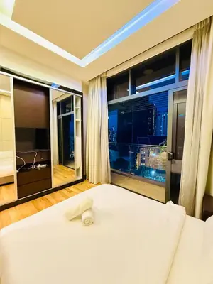a bedroom with a white bed and a large window at Dorsett Residence KL in Kuala Lumpur