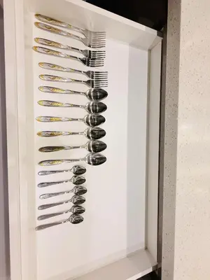 a rack of wine glasses in a white cabinet at Dorsett Residence KL in Kuala Lumpur
