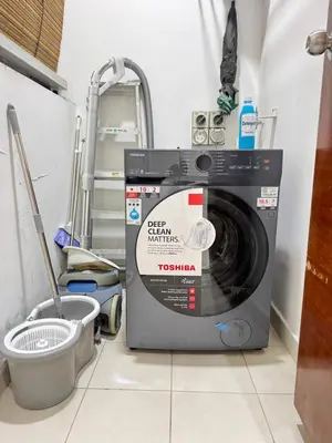 a washing machine sitting on a floor in a room at KLCC Marc Residence by AZ Line in Kuala Lumpur