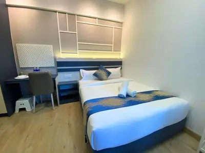 a bedroom with a bed and a desk with a computer at The Colony By Infinitum KLCC - Aura Suites in Kuala Lumpur