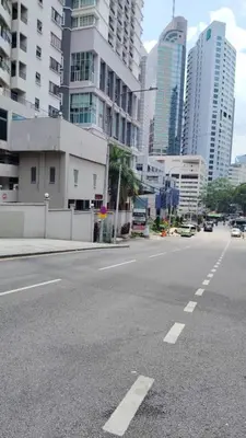 an empty street in a city with tall buildings at AL Seri Bukit Ceylon in Kuala Lumpur
