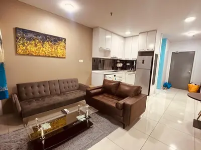 a living room with a couch and a table at Studio Apartment KLCC Area in Kuala Lumpur