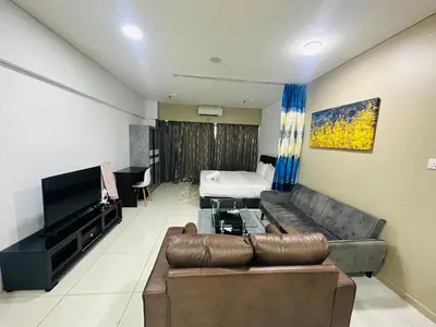 a living room with a couch and a television at Studio Apartment KLCC Area in Kuala Lumpur