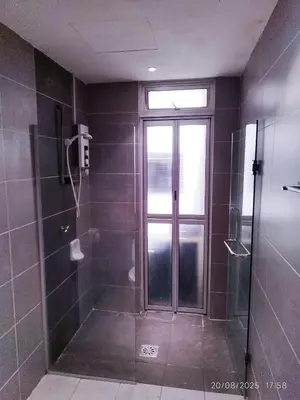 a bathroom with a shower and a glass door at Arina Uniti Kampung Baru HKL - Idealhub in Kuala Lumpur