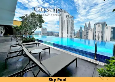 a large swimming pool with a view of a city at Majestic Residence Kuala Lumpur by Cityscape in Kuala Lumpur