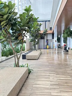 a hallway with a tree in the middle of a building at The Colony By Infinitum With Rooftop Pool in Kuala Lumpur