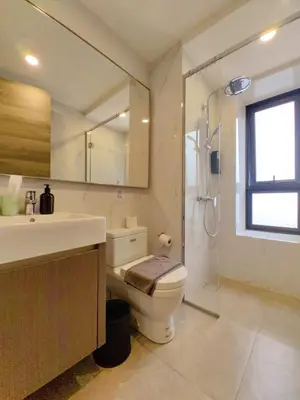 a bathroom with a toilet and a sink and a shower at TRX Agile Bukit Bintang Cozy 2 Bedroom and 1 Living Room Suites in Kuala Lumpur
