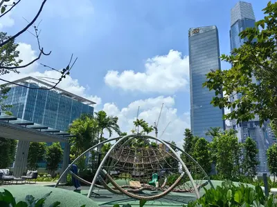 a roller coaster in a park with tall buildings at TRX Agile Bukit Bintang Cozy 2 Bedroom and 1 Living Room Suites in Kuala Lumpur