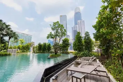 a pool of water with tables and benches in a city at TRX Agile Bukit Bintang Cozy 2 Bedroom and 1 Living Room Suites in Kuala Lumpur