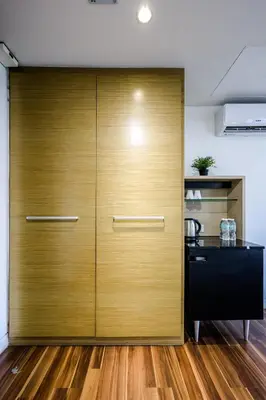 a large wooden door in a kitchen with wood floors at D'Majestic by Aspire Suites in Kuala Lumpur