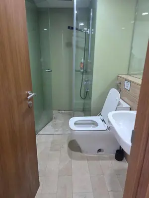 a bathroom with a shower and a toilet and a sink at Vortex suites klcc by KAZI in Kuala Lumpur