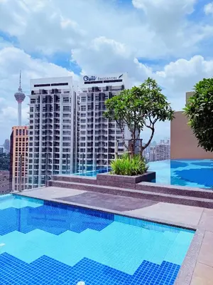a swimming pool on the roof of a building at The Majestic Residence KLCC By Castle in Kuala Lumpur