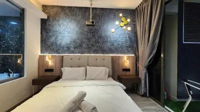a bedroom with a white bed and a large window at Dsir Lustful KL Jacuzzi NFLX Prjscn120 TV65 in Kuala Lumpur