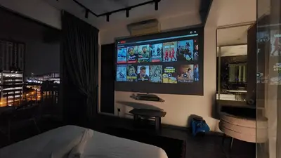 a bedroom with a bed and a large tv on the wall at Dsir Lustful KL Jacuzzi NFLX Prjscn120 TV65 in Kuala Lumpur