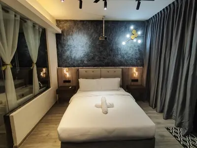 a bedroom with a bed with a teddy bear on it at Dsir Lustful KL Jacuzzi NFLX Prjscn120 TV65 in Kuala Lumpur