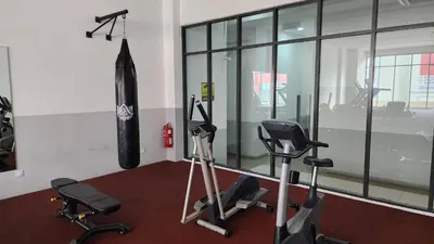 a gym with two exercise bikes and an umbrella at Dsir Lustful KL Jacuzzi NFLX Prjscn120 TV65 in Kuala Lumpur