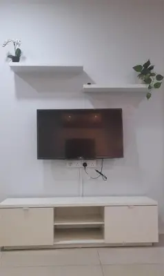 a flat screen tv on a white wall at Kuala Lumpur Mont Kiara Arcoris SOHO 5 Pax, Walk to Mall, Pool, WIFI in Kuala Lumpur