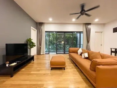a living room with a couch and a flat screen tv at St Mary Residence by PILLOWTALKS in Kuala Lumpur