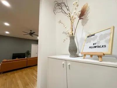 a living room with a vase with flowers on a counter at St Mary Residence by PILLOWTALKS in Kuala Lumpur