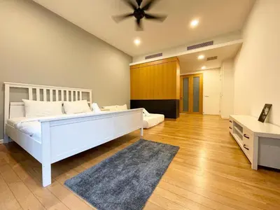 a bedroom with a white bed and a ceiling fan at St Mary Residence by PILLOWTALKS in Kuala Lumpur