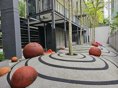 a building with a spiral design in front of a building at St Mary Residence by PILLOWTALKS in Kuala Lumpur