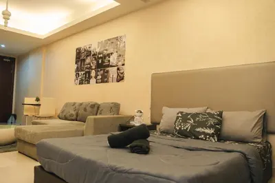 a living room with a bed and a couch at KL Hartamas Studio, Wifi Smart TV in Kuala Lumpur