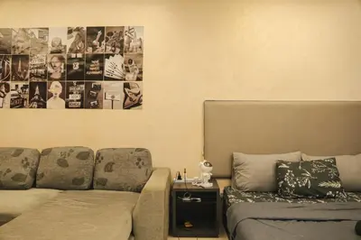 a living room with a couch and a bed at KL Hartamas Studio, Wifi Smart TV in Kuala Lumpur