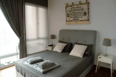 a bedroom with a bed with pillows and a window at KL Luxury Residence 3BR Golden Triangle in Kuala Lumpur