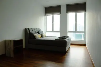 a living room with a couch and two windows at KL Luxury Residence 3BR Golden Triangle in Kuala Lumpur