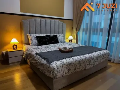 a bedroom with a large bed with two towels on it at KLCC 23A Premium 1B1R with Best View Infinity Pool and Netflix 1080HD in Kuala Lumpur