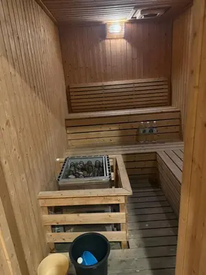 an inside of a sauna with a bucket in it at ROBERTSON RESIDENCE KUALA LUMPUR By IKNAS SUITES in Kuala Lumpur