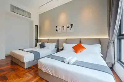 a bedroom with two beds and a window at The Mews KLCC Home Plus in Kuala Lumpur