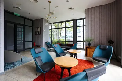 a living room with blue chairs and a table at The Mews KLCC Home Plus in Kuala Lumpur
