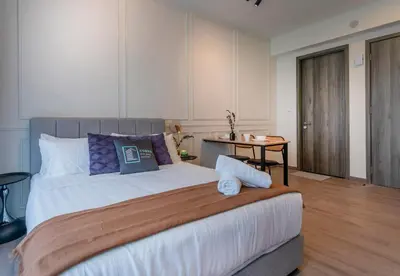 a bedroom with a large bed and a table at Agile Bukit Bintang TRX KL City by Cobnb in Kuala Lumpur